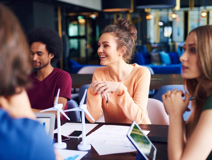 Young,Coworkers,Talking,At,Conference,Table Young coworkers talking at conference table